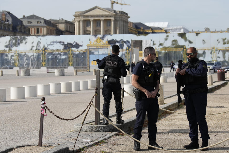 French police officers guard the entrance of the Chateau de Versailles after a security alert Tuesday, Oct. 17, 2023 in Versailles, west of Paris. The Palace of Versailles, one of France's most visited tourist attractions, is being evacuated for a security scare. It's the second time in four days the palace has had to close, with France on heightened alert against feared attacks after the fatal stabbing of a school teacher. (AP Photo/Christophe Ena)