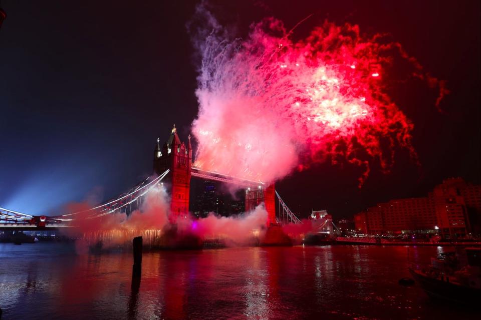 A light display over the River Thames and fireworks on Tower Bridge in London, as London's normal New Year's Eve fireworks display was cancelled due to the coronavirus pandemic (PA)
