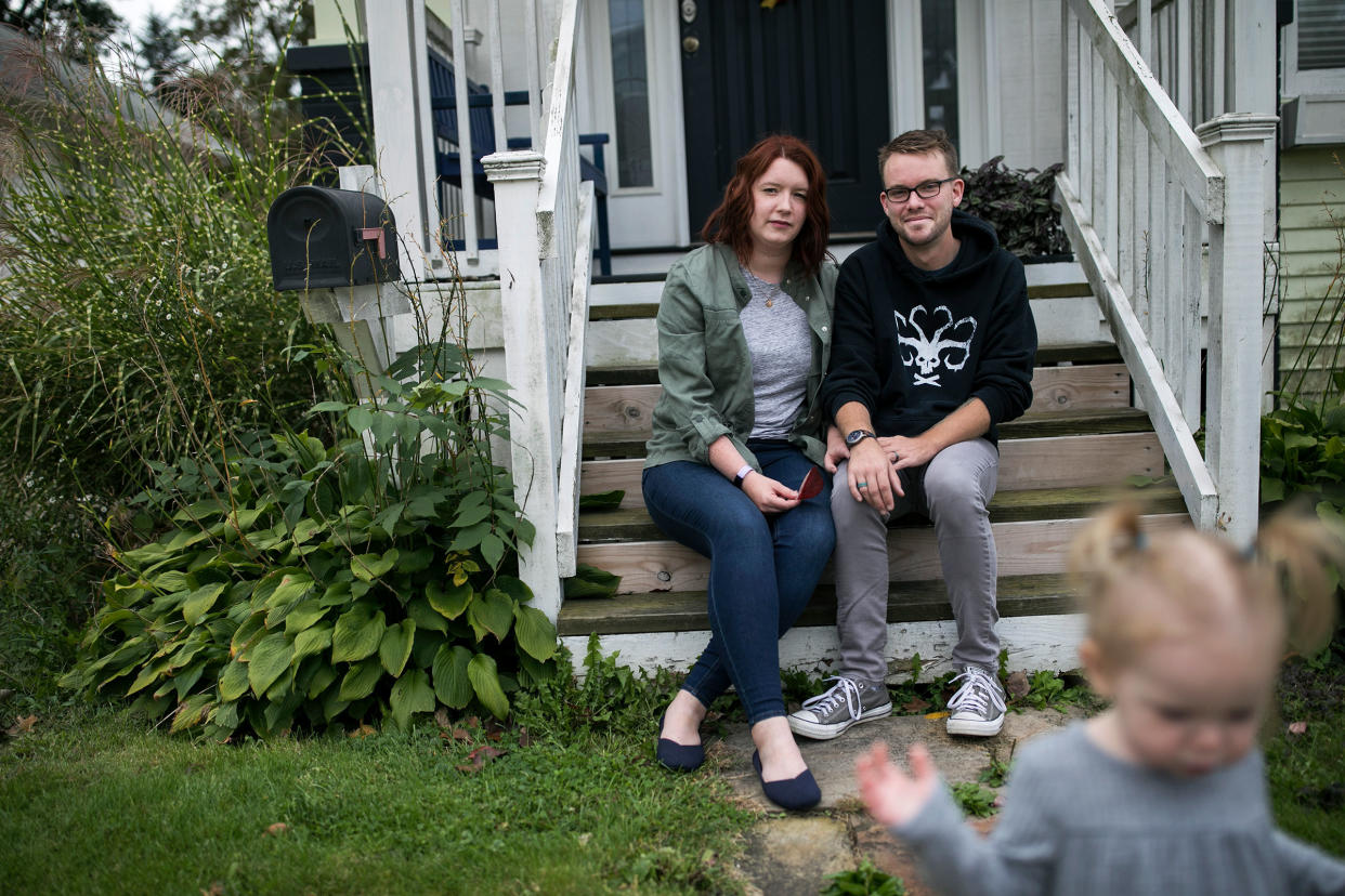 Shelby Parker sits outside of her home with her husband Ben and daughter Abby in Cuyahoga Falls, Ohio on Oct. 3, 2020. Parker planned to get pregnant this year, but is contemplating not trying for a second child at all now due to the coronavirus.