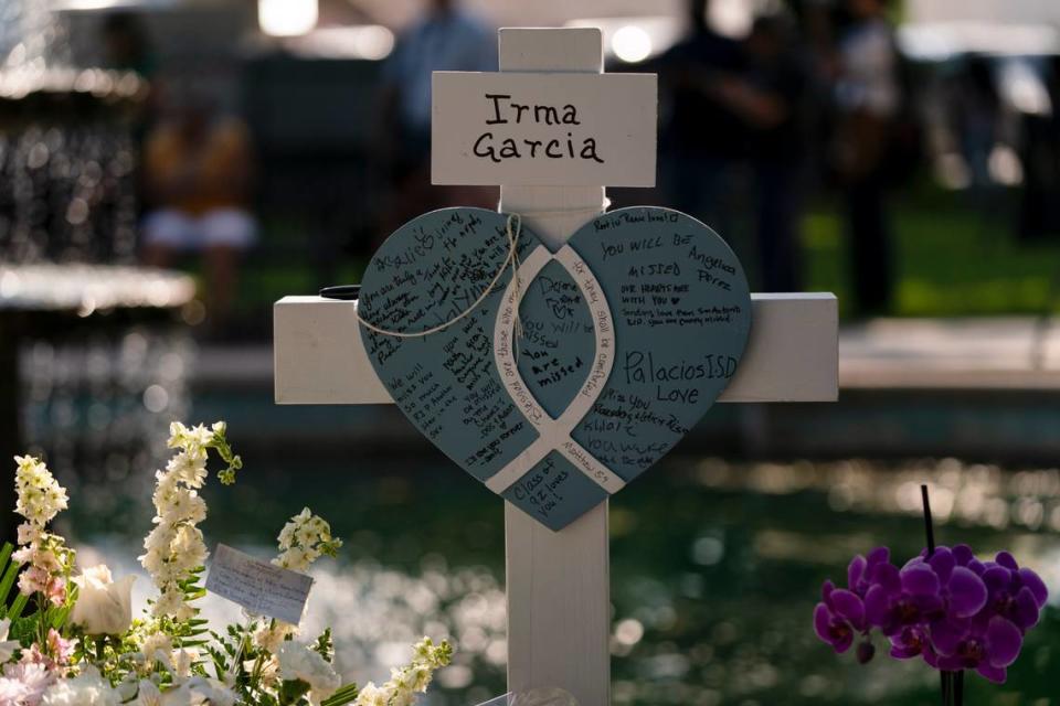 Messages are written on a cross honoring Irma Garcia, a teacher who was killed in this week’s elementary school shooting, in Uvalde, Texas, Thursday, May 26, 2022. (AP Photo/Jae C. Hong)