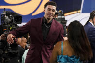 Chris Duarte, right, reacts after being selected as the 13th overall pick by the Indiana Pacers during the NBA basketball draft, Thursday, July 29, 2021, in New York. (AP Photo/Corey Sipkin)