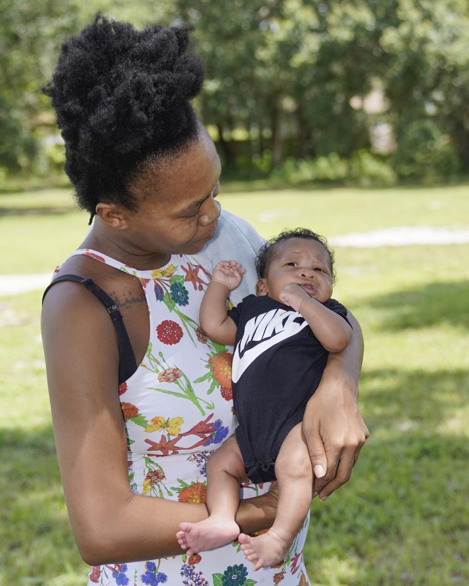 Venessa Aiken holds her son Jahzir Robinson, five weeks old, outside their home Sunday, Aug. 21, 2022, in Orlando, Fla. States around the country are making it easier for newborn moms to keep Medicaid in the year after childbirth, a crucial time when depression and other health problems can develop.(AP Photo/John Raoux)