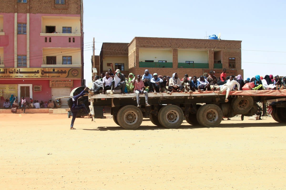 People fleeing a street battle between the forces of two rival Sudanese generals are transported on the back of a truck in Khartoum (AFP/Getty)