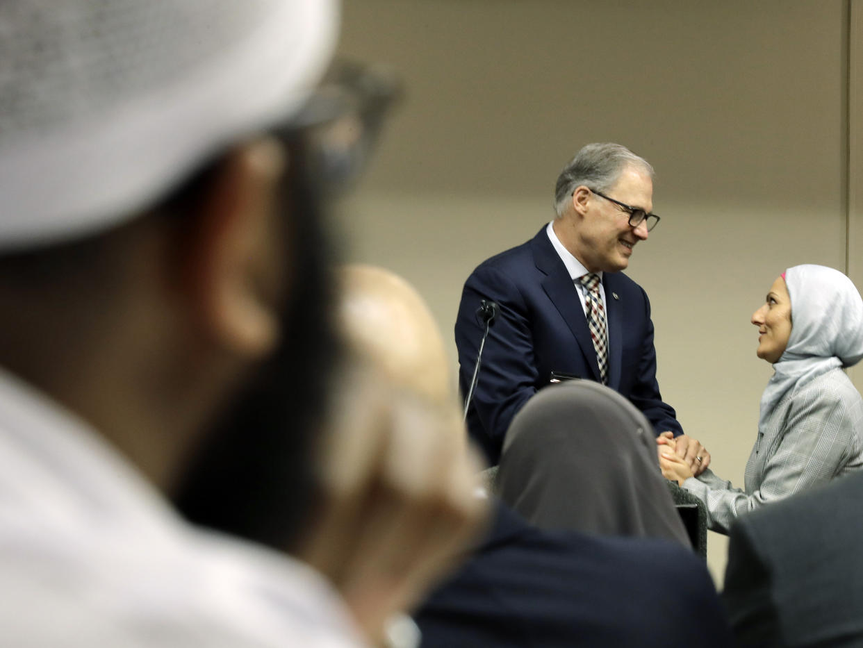 Washington Gov. Jay Inslee (D-Wash.), center, greets Muslim constituents on March 21. As Muslim political engagement has grown, politicians have shown greater interest in outreach. (Photo: ASSOCIATED PRESS/Ted S. Warren)