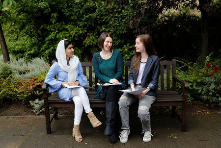 Malala Yousefzai (L) speaks with fellow students Bethany Lucas (C) and Beatrice Kessedjian after collecting her 'A' level exam results at Edgbaston High School for Girls in Birmingham, Britain August 17, 2017. REUTERS/Darren Staples