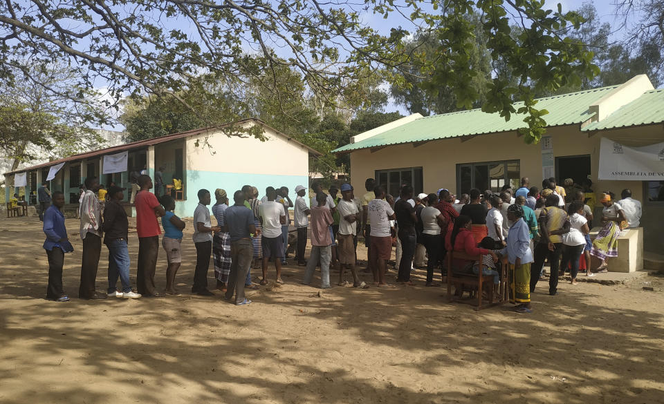 Voters queue to cast their votes in Bilene, Mozambique, Tuesday, Oct. 15, 2019 in the country's presidential, parliamentary and provincial elections. Polling stations opened across the country with 13 million voters registered to cast ballots in elections seen as key to consolidating peace in the southern African nation. (AP Photo/Tom Bowker)