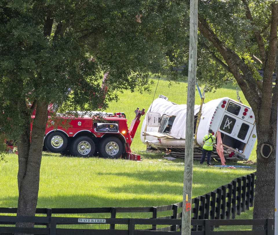Authorities work at the scene of a deadly crash after a bus carrying farmworkers collided with a pickup truck on State Road 40 Tuesday, May 14, 2024, near Dunnellon, Fla. (AP Photo/Alan Youngblood)
