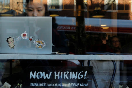 FILE PHOTO: A "Now Hiring" sign sits in the window of Tatte Bakery and Cafe in Cambridge, Massachusetts, U.S., February 11, 2019. REUTERS/Brian Snyder/File Photo