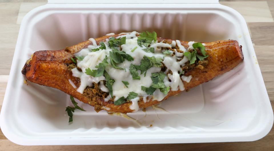 The Canoa, a whole sweet plantain stuffed with ground beer, pork and cheese, at the newly opened Empanada Shop in the village of East Rochester Friday, May 10, 2024.