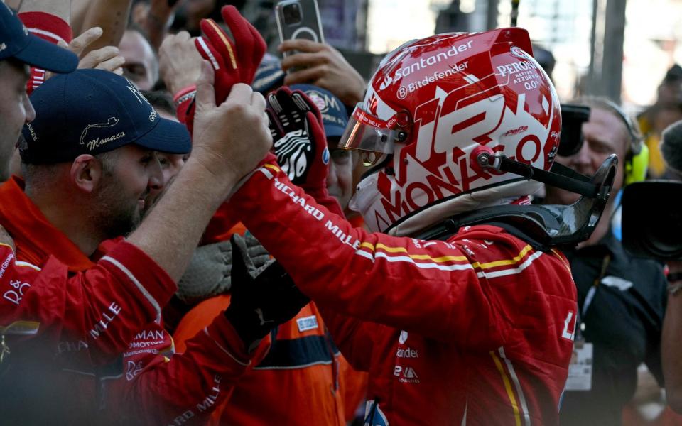 Ferrari's Monegasque driver Charles Leclerc celebrates with his team