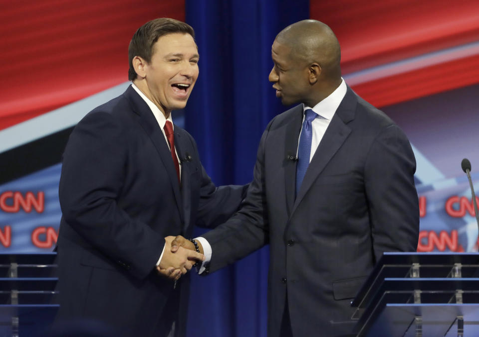 Florida Republican gubernatorial candidate Ron DeSantis, left, shakes hands with Democratic gubernatorial candidate Andrew Gillum after a CNN debate, Sunday, Oct. 21, 2018, in Tampa, Fla. (AP Photo/Chris O'Meara)