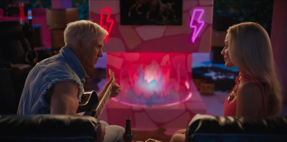 Ryan Gosling playing guitar as Ken and Margot Robbie as Barbie in "Barbie."