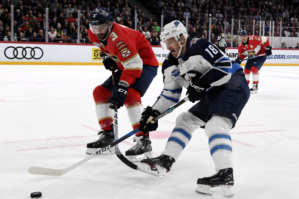 Keith Yandle, left, of Florida Panthers and Bryan Little of Winnipeg Jets fight for the puck during the ice hockey NHL Global Series match Florida Panthers vs Winnipeg Jets in Helsinki, Finland on Thursday, November 1, 2018. (Martti Kainulainen/Lehtikuva via AP)