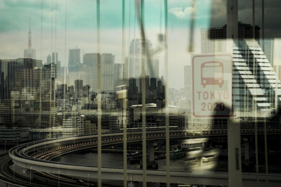 The skyline of Tokyo is seen through a bus window from the Rainbow Bridge ahead of the 2020 Summer Olympics, Wednesday, July 14, 2021, in Tokyo. (AP Photo/Jae C. Hong)