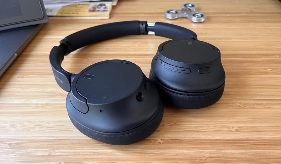 The Sony WH-CH720N headphones, black, resting on a desk.