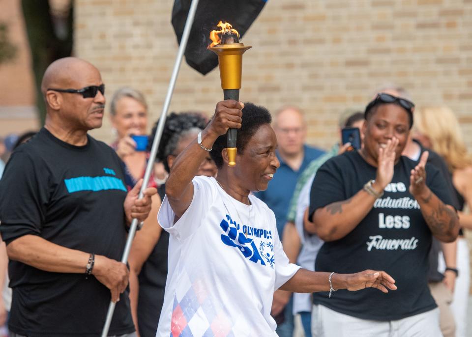 Loretta Claiborne carries the Special Olympics torch into a celebration in her honor at York High on Friday, July 7, 2023.