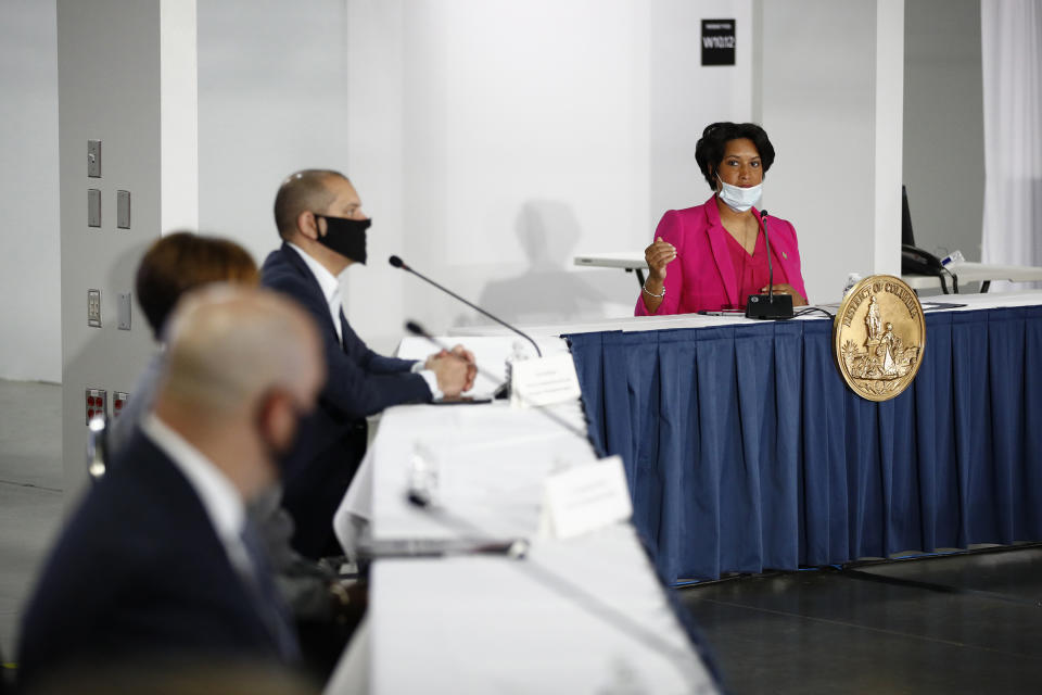 D.C. Mayor Muriel Bowser, right, speaks during a news conference about the coronavirus inside the Walter E. Washington Convention Center on May 11. | Patrick Semansky—AP