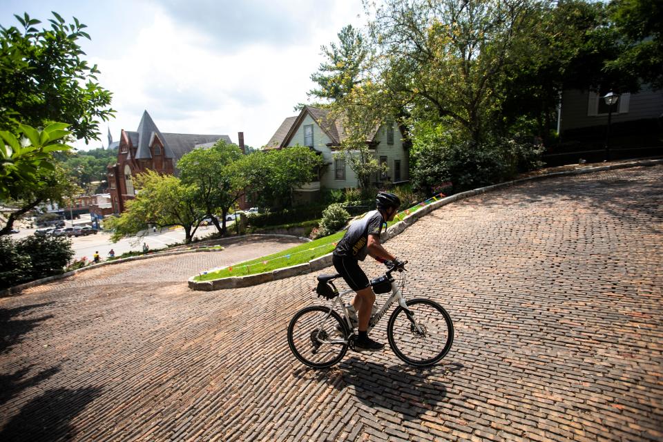 Riders power their way up a 21% grade while completing the Rally to the Alley challenge during RAGBRAI in 2019 in Burlington.