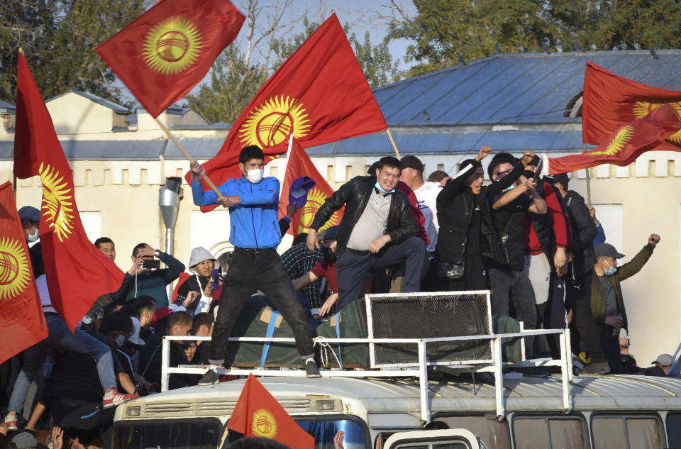 People protest during a rally against the results of a parliamentary vote in Bishkek, Kyrgyzstan, Monday, Oct. 5, 2020. Large crowds of people have gathered in the center of Kyrgyzstan's capital to protest against the results of a parliamentary election, early results of which gave the majority of seats to two parties with ties to the ruling elites amid allegations of vote buying. (AP Photo/Vladimir Voronin)