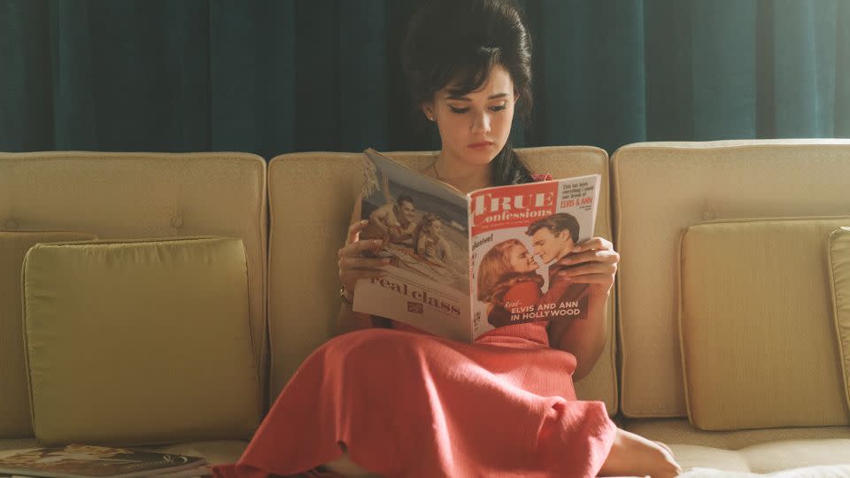 The pink dress worn as Priscilla reads tabloid gossip about her husband's oft-alleged dalliances was inspired by a historical Ann-Margret look. - Sabrina Lantos/Courtesy A24