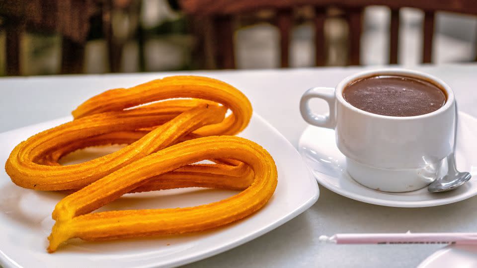 Fried dough dipped in chocolate? Yes, please. - Roberto Machado Noa/Moment RF/Getty Images