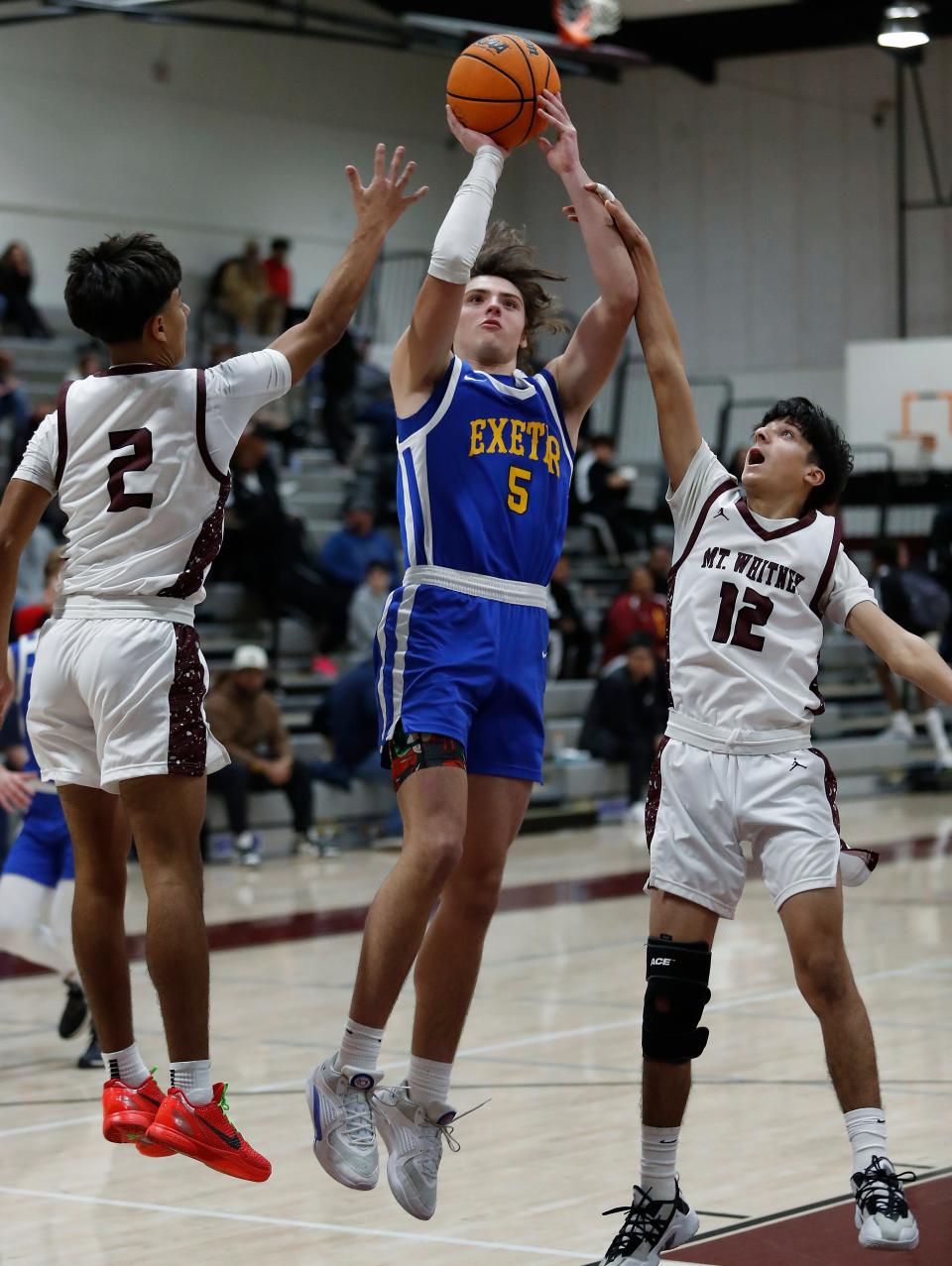 Exeter's Blaine McFall looks to score against Mt. Whitney's Xavery Soto, right, during their 72nd annual Polly Wilhelmsen Invitational Basketball Tournament game in Visalia, Calif., Wednesday, Dec. 27, 2023.