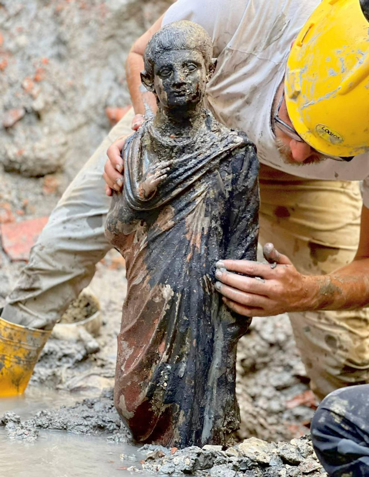 Archaeologists work at the site of the discovery of two dozen well-preserved bronze statues from an ancient Tuscan thermal spring in San Casciano dei Bagni, central Italy, in this update photo made available by the Italian Culture Ministry, Thursday, Nov. 3, 2022. (Italian Culture Ministry via AP)