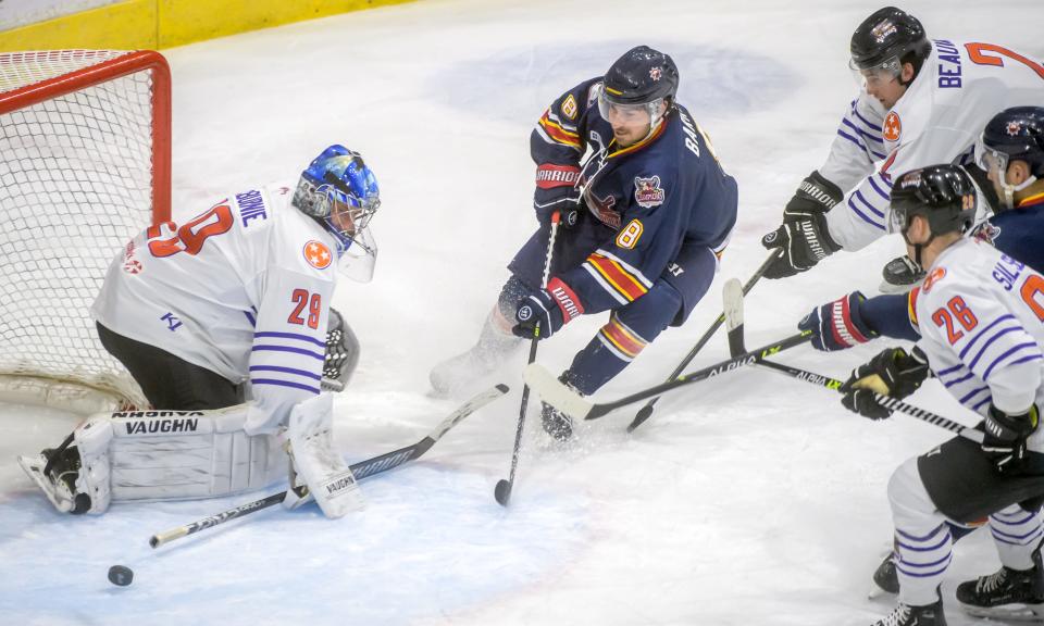 Peoria's Tyler Barrow (8) puts a shot on Knoxville goaltender Bailey MacBurnie in the third period Friday, Jan. 13, 2023 at Carver Arena in Peoria. MacBurnie knocked it wide with his stick. The Rivermen fell to the Ice Bears 6-4.