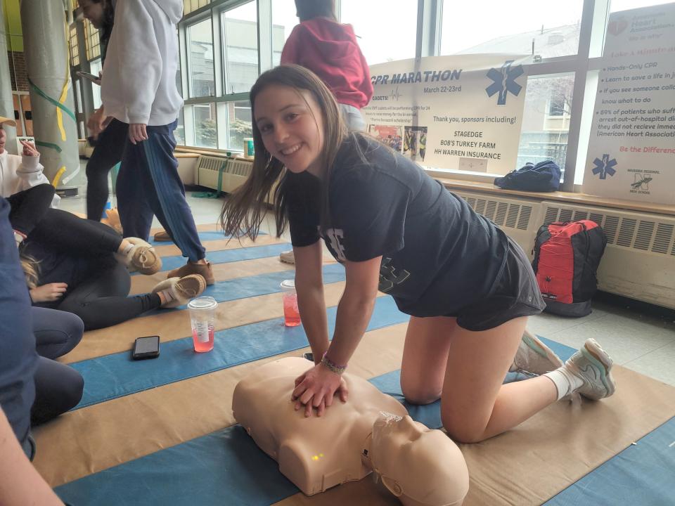 Nashoba senior Holly Bechard of Bolton performs hands-only CPR on a mannequin as part of students' 24-hour marathon Friday into Saturday.