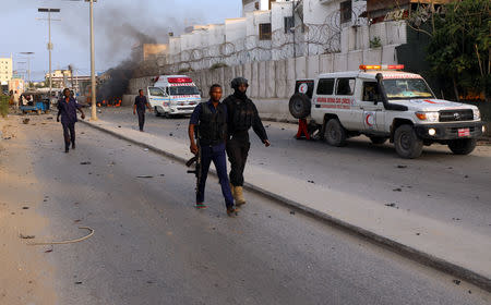 Somali security officers walk from the scene of an explosion in Mogadishu, Somalia November 9, 2018. REUTERS/Feisal Omar