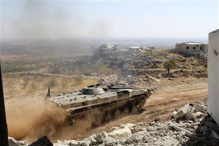 A Free Syrian Army tank drives on al-Arbaeen mountain in the Idlib countryside September 20, 2013. Picture taken September 20, 2013. REUTERS/Houssam Abo Dabak