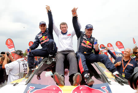 Dakar Rally - 2018 Peru-Bolivia-Argentina Dakar rally - 40th Dakar Edition stage fourteen, Cordoba to Cordoba - January 20, 2018. Carlos Sainz (R) of Spain celebrates with co-pilot Lucas Cruz (L) of Spain and with Bruno Famin, race director of the Peugeot team after winning Dakar rally. REUTERS/Andres Stapff