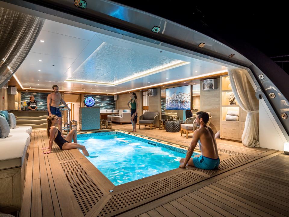 People at pool of Victorious superyacht