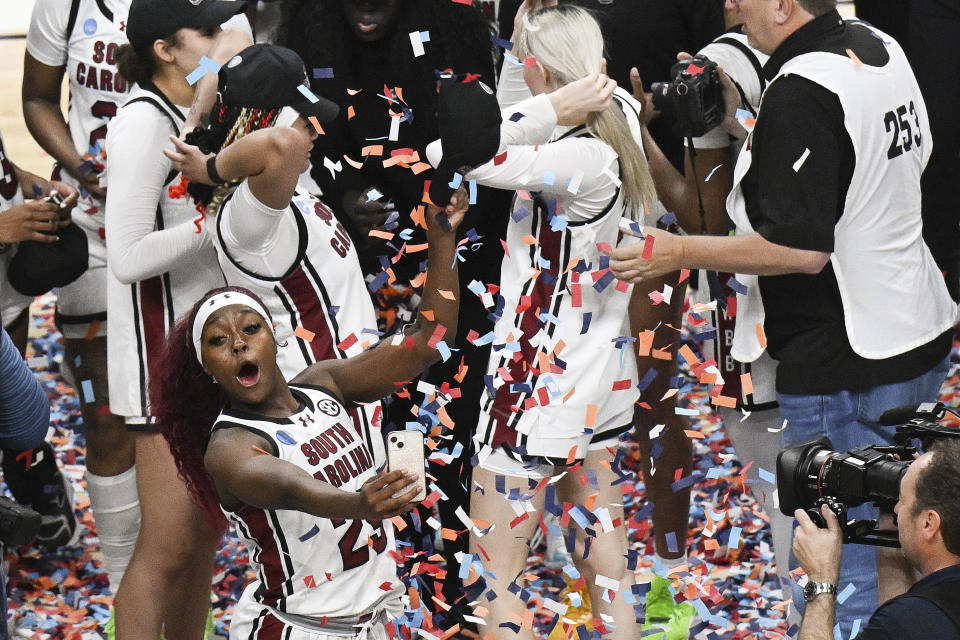South Carolina guard Bree Hall (23) takes a selfie on the court after defeating Oregon State in an Elite Eight round college basketball game during the NCAA Tournament, Sunday, March 31, 2024, in Albany, N.Y. (AP Photo/Hans Pennink)