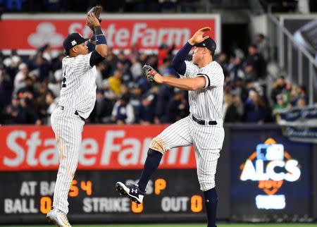 Oct 17, 2017; Bronx, NY, USA; New York Yankees right fielder Aaron Judge (right) and second baseman Starlin Castro (14) celebrate after defeating the Houston Astros in game four of the 2017 ALCS playoff baseball series at Yankee Stadium. Yankees won 6-4. Mandatory Credit: Robert Deutsch-USA TODAY Sports