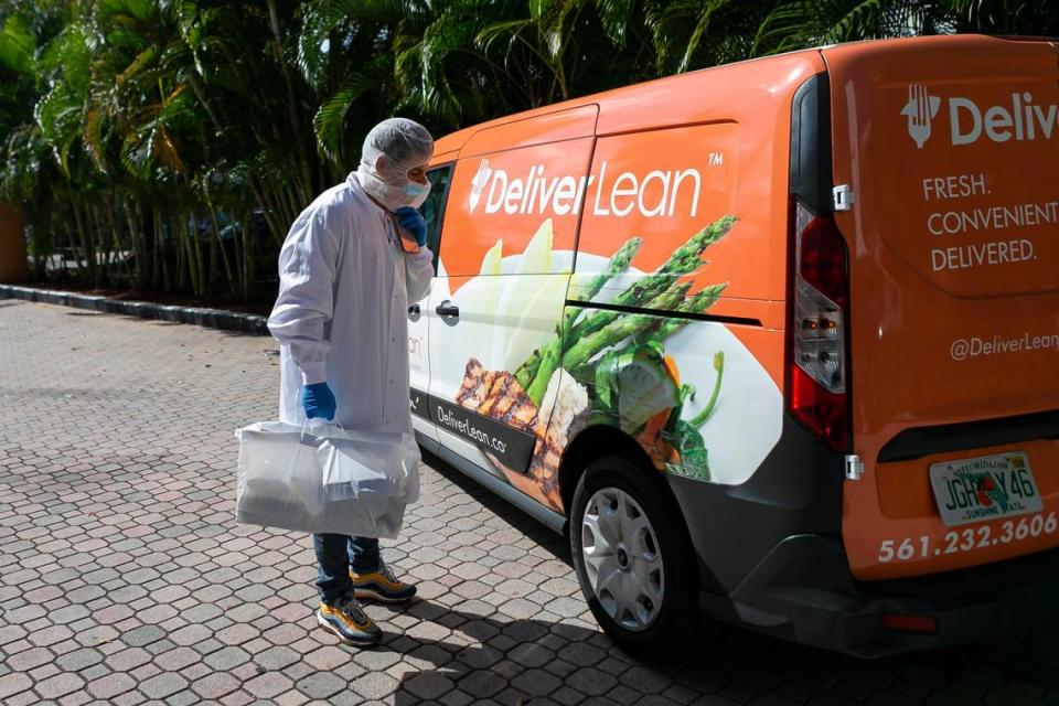 Yuri Kouzenkov, the director of operations for DeliverLean, delivers food to seniors in Brickell, Florida on Wednesday, March 25, 2020. DeliverLean has been hired by Miami-Dade County to help provide elderly residents with free meals during the COVID-19 pandemic.