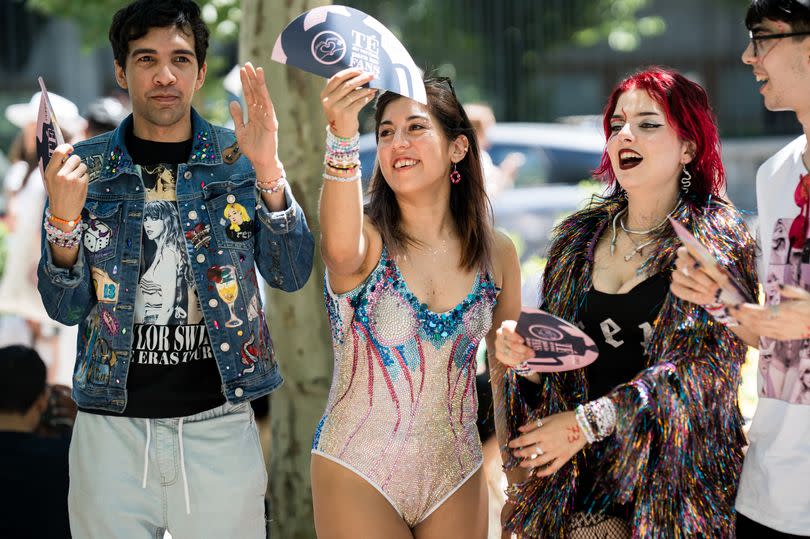 Several fans of Taylor Swift 'swifties' wait in the vicinity of the Santiago Bernabeu Stadium, before the second concert of the singer, on 30 May, 2024 in Madrid, Spain. One wears an Eras Tour-based denim jacket, another wears a Lover bodysuit and a third wears a Reputation-inspired outfit and makeup/jewellery