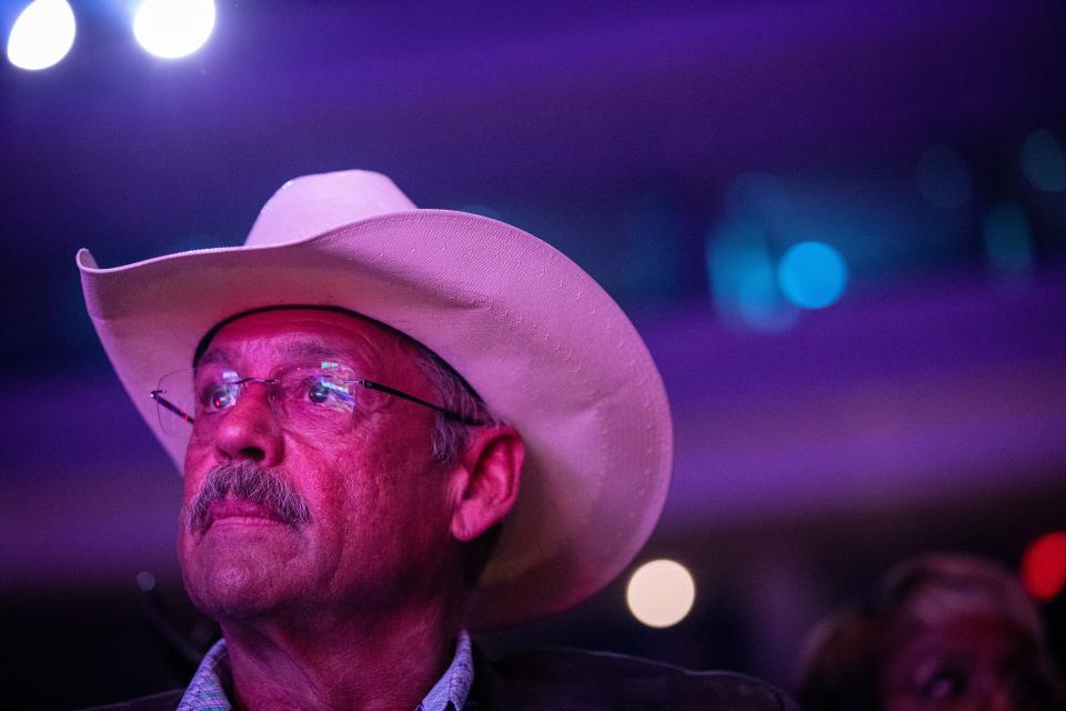 Mark Finchem, then an Arizona secretary of state candidate, listens to a speaker discuss the importance of state elections at the Unite and Win Rally organized by Turning Point Action in Phoenix on Aug. 14, 2022.