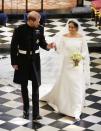 <p>Meghan, Duchess of Sussex, married Prince Harry in 2018 wearing a minimal boat neck gown by British fashion designer Clare Waight Keller, then-artistic director of Givenchy. The minimal gown was accented with an embroidered veil. </p>