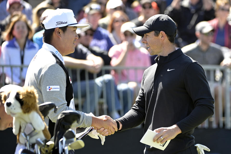 Sungjae Im, left, of South Korea, and Rory McIlroy, of Northern Ireland, shake hands before hitting their tee shots on the first hole during the third round of the Arnold Palmer Invitational golf tournament, Saturday, March 7, 2020, in Orlando, Fla. (AP Photo/Phelan M. Ebenhack)