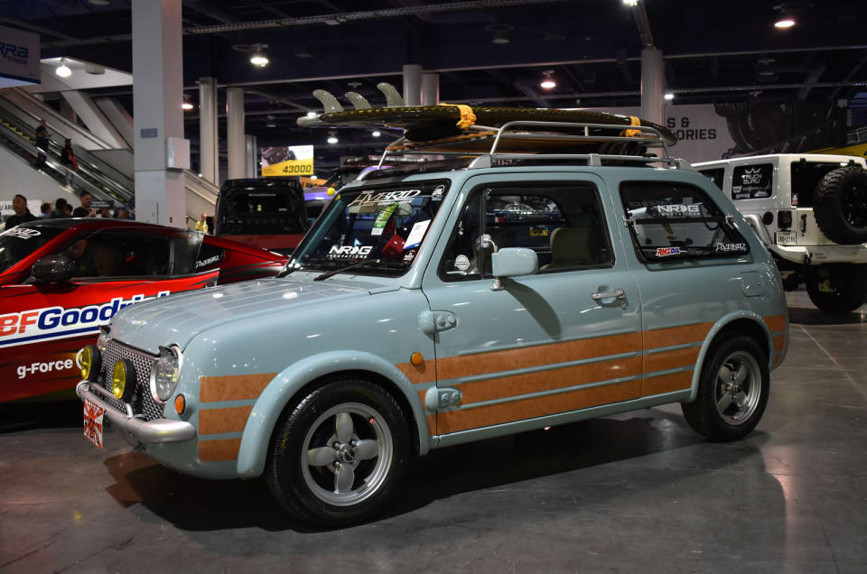 <p>The woodgrain decal work on Christopher Malloy’s 1,000cc Pao is designed to evoke old-school SoCal surfer wagons – a theme continued by the carbon-fiber surfboard on the roof, made by The Carbon Lab. Further modifications include fog lights and a refurbished interior.</p>