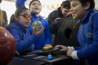 Blind school children take part in a sensorial experience with tools created by NASA and Edinburgh University to experience an eclipse, during an event in the Helen Keller school in Santiago, Chile, Tuesday, June 25, 2019. The event comes exactly one week ahead of a total solar eclipse which is set to be fully visible in various South American countries, including Chile. (AP Photo/Esteban Felix)