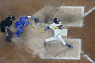 Milwaukee Brewers' Victor Caratini hits a walk off three run home run during the 10th inning of a baseball game against the Chicago Cubs Monday, July 4, 2022, in Milwaukee. (AP Photo/Morry Gash)