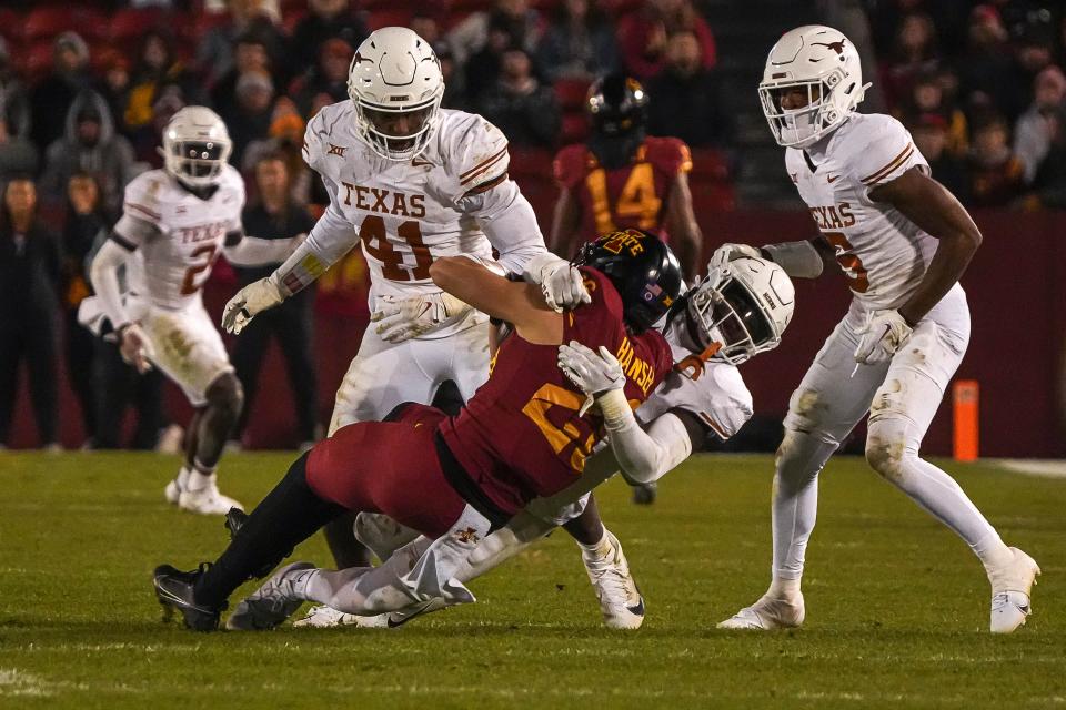 Texas linebacker Anthony Hill Jr. tackles Iowa State running back Carson Hansen during their 2023 game in Ames, Iowa. Hill, who was a freshman All-American, played primarily either on the edge or at outside linebacker. But he's switching to Jaylan Ford's middle spot this year.