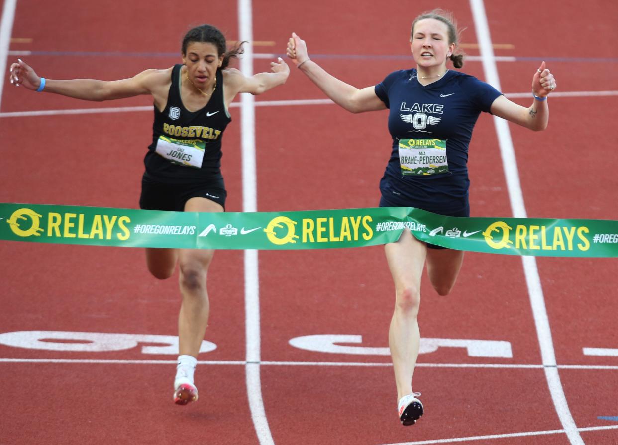 Lake Oswego's Mia Brahe-Pedersen, right, edges Roosevelt's Lilly Jones at the tape to win the Girls 100 Meter Dash Varsity during the Oregon Relays at Hayward Field Saturday, April 23, 20222.