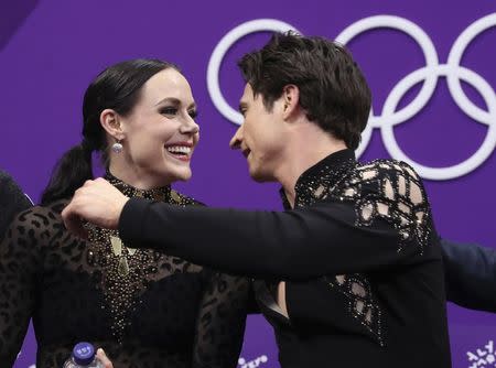 Figure Skating - Pyeongchang 2018 Winter Olympics - Ice Dance short dance competition - Gangneung Ice Arena - Gangneung, South Korea - February 19, 2018 - Tessa Virtue and Scott Moir of Canada react to their score. REUTERS/Lucy Nicholson