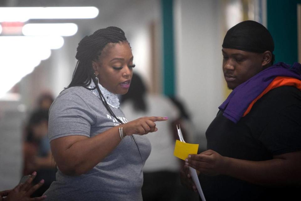 Principal Christina Hanson helps direct a parent to their child’s classroom at Rocketship Dennis Dunkins Elementary in Fort Worth, Texas, on Saturday, Aug. 6, 2022. The new charter school opened its doors to parents and students the weekend before school began Monday.