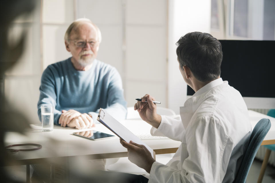 Doctor talking to senior patient in medical practice