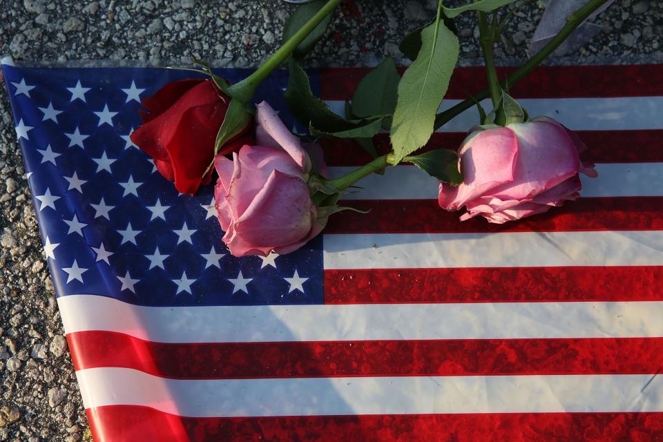 <p>Flowers and an American flag were placed on the ground near the Pulse nightclub, in Orlando, Fla. (Joe Raedle/Getty Images) </p>