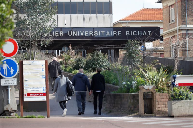 People walk towards the entrance of the Bichat Hospital in Paris